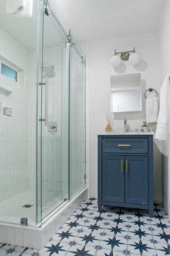 a bathroom with a blue cabinet and a shower at Newly Renovated Gem Mins to Convention Center, Beaches and Downtown LB A in Long Beach