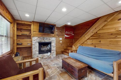 a room with a fireplace in a log cabin at Day Dreamer in Mineral Bluff