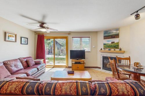 a living room with a couch and a tv at The West 3507 in Steamboat Springs