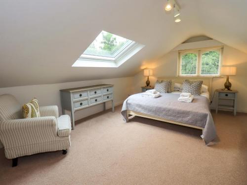 a attic bedroom with a bed and a skylight at Underheron in Grasmere