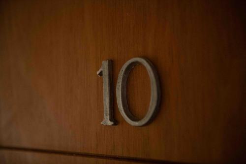a wooden door with the number on it at Hotel Le Charme in San Carlos de Bariloche