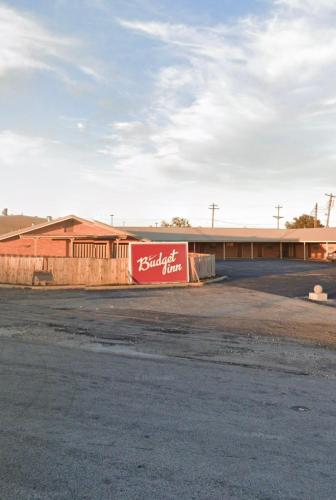 a building with a coca cola sign on the side of it at Budget Inn in Coleman