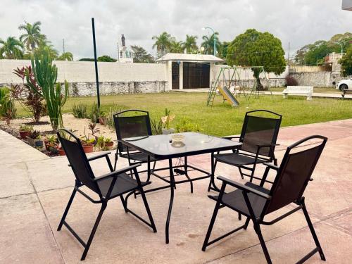 a table and four chairs on a patio at Stella by Türk in Chetumal