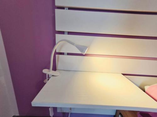a white lamp sitting on the side of a bed at Dai Massari in Villaggio Azzurro