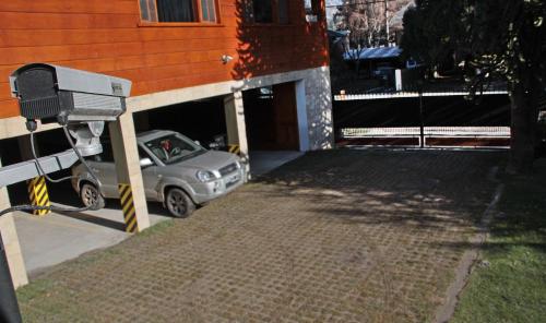 a car parked in a garage next to a building at Hostería Antares Patagonia by Visionnaire in San Martín de los Andes