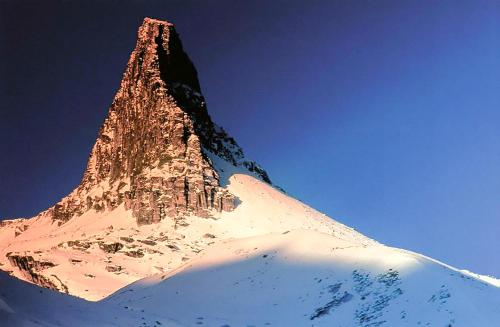 a rocky mountain with snow on top of it at Grosshus Vals in Vals