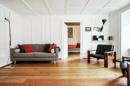a living room with a couch and a chair at Grosshus Vals in Vals