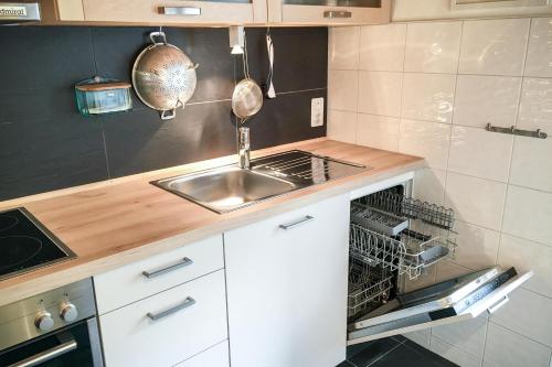 a kitchen with a sink and a dishwasher at Grosshus Vals in Vals