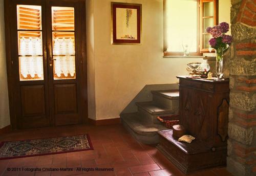 a living room with stairs and a door and a window at Campomaggio in Pistoia