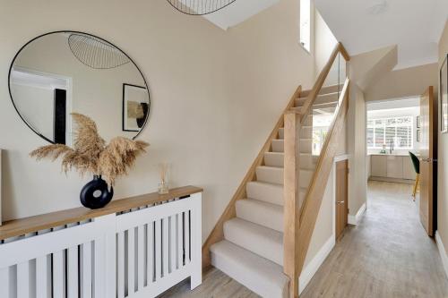 a hallway with a staircase and a mirror at The Squirrels in Plymouth