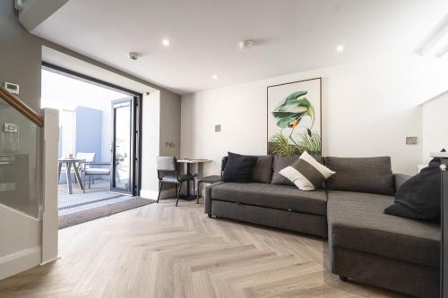 a living room with a couch and a table at Bushmills Luxury Getaway w Bath in Bushmills