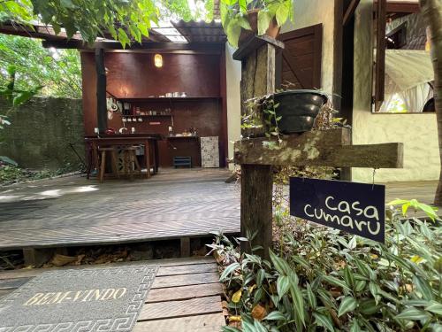 a wooden walkway to a house with a sign on it at VILA AMZ, 3 minutos da Praia do Lago! in Alter do Chao