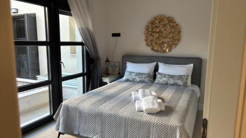 a bedroom with a bed with towels on it at The Mulberry House Heritage by the Sea in Alexandroupoli