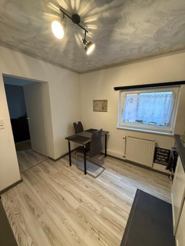 a living room with a ceiling fan and a table at Apartment in Bad Nauheim BX in Bad Nauheim