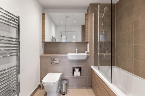 a bathroom with a toilet and a sink and a shower at Khayat Homes - The Lasgidi - Two Bed Apt in Barking