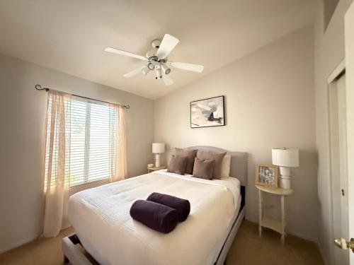 a bedroom with a large bed with a ceiling fan at Cactus Bonito in Phoenix