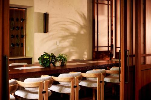 a dining room with a long table and chairs at 1 Hotel Seattle in Seattle