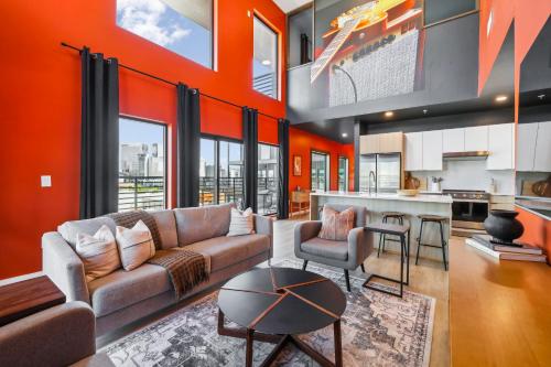 a living room with a couch and a table at The Rhythm and Rooftop Penthouse Walk To Broadway with Pool and Amazing Views in Nashville