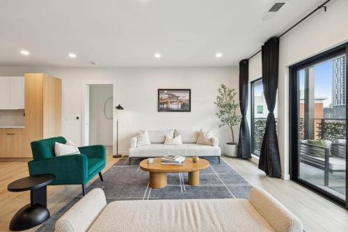 a living room with a couch and a table at Skyline Nights in Downtown Nashville Walk to Broadway with Pool and Gym in Nashville