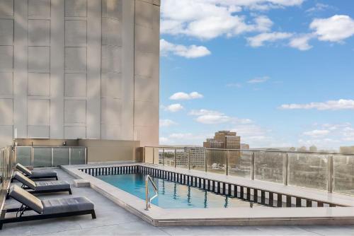 a swimming pool on the roof of a building at City Pad with Hyde Park Views, Walk to Everything! in Sydney