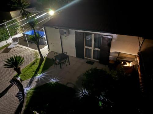 a house with a patio at night with a table and chairs at Villettine le Marie in Ricadi