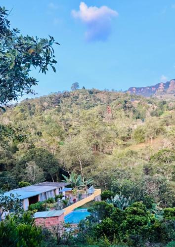 a resort with a swimming pool and a mountain at Cabañas Avani in San Francisco