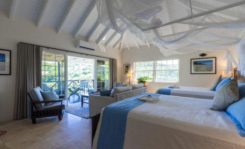 a bedroom with a bed and a living room at Admiral's Inn and Gunpowder Suites in English Harbour Town