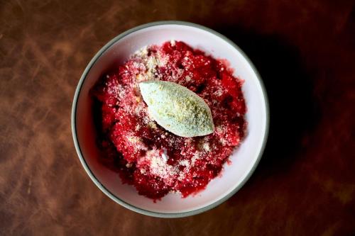 a bowl of red dessert with a spoon in it at 1 Hotel Seattle in Seattle