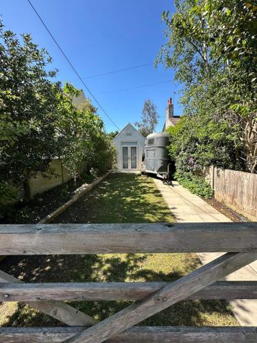 a wooden fence in front of a house at The Telephone exchange very quaint hot tub stay in Scarisbrick