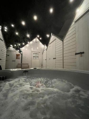 a large pool of water in a room with buildings at The Telephone exchange very quaint hot tub stay in Scarisbrick