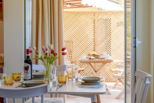 a white table with a vase of flowers on it at Ridomo Sea View Villas Camellia & Jasmine in Avia