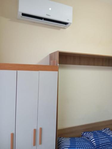 a bedroom with two bunk beds with a tv on the wall at Studio Líder 1309 in Niterói