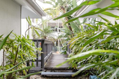 a wooden staircase in a building with plants at Outrigger Bay in Byron Bay