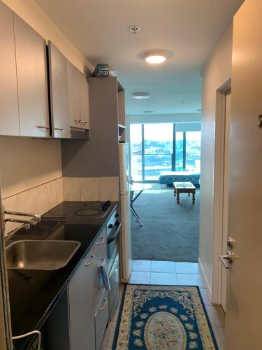a kitchen with a sink and a stove at Imperial Garden2 in Auckland
