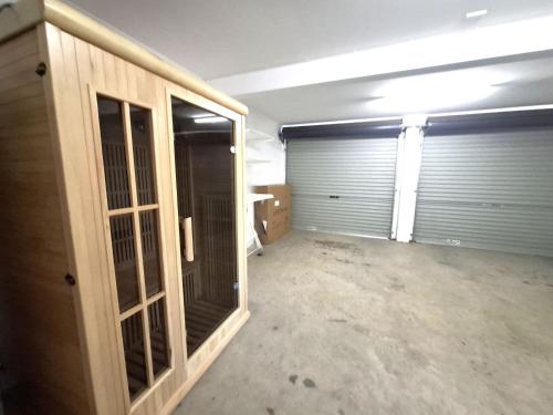 an empty garage with two garage doors in it at Silvertrees 5 - Central 3BR Townhouse l Lake Views l Spa l BBQ l WiFi in Jindabyne