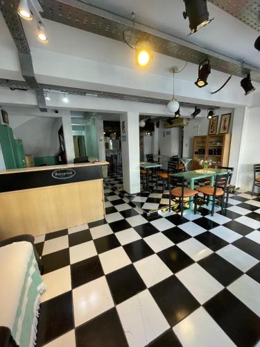 a checkered floor in a restaurant with tables and chairs at HOTEL JUAN b JUSTO GARDEN in Mendoza