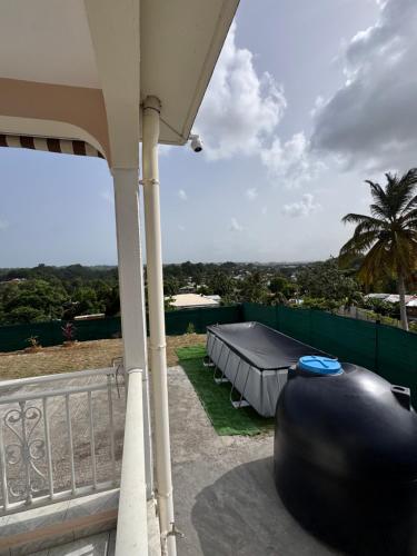 a view from the back of a house with a table at VILLA Papillon in Les Abymes