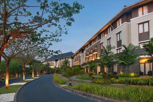 a street with a row of apartment buildings at Mercure Bali Nusa Dua in Nusa Dua