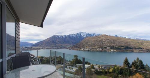 a room with a view of a lake and mountains at Goldrush #1 in Queenstown