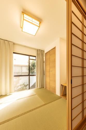 a bedroom with a bed and a window at Mars Hotel in Tokyo