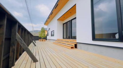 a wooden deck with benches on a house at Private Villa 蒼 Lala & Lino in Kyotango