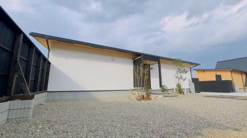 a white building with a black roof at Private Villa 蒼 Lala & Lino in Kyotango