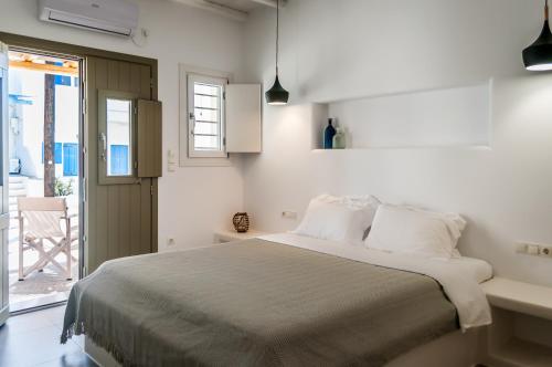 Postel nebo postele na pokoji v ubytování Vilos Suites