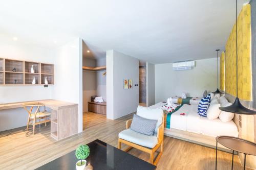 a bedroom with a bed and a desk in a room at Antiya Hotel Phuket in Phuket Town
