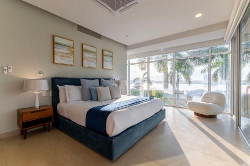 a bedroom with a large bed and a large window at Capitalia Tres Mares Beach Residences & Marina in Puerto Vallarta