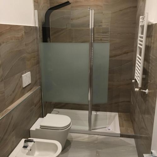 a bathroom with a shower and a toilet and a sink at Roma Veneto Relais in Rome