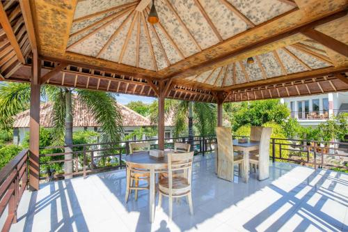 an outdoor patio with a wooden gazebo at Govardhan Nusa Penida in Nusa Penida