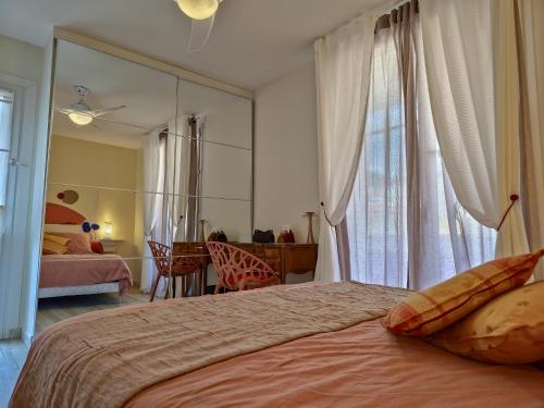 une chambre avec un grand miroir et un lit dans l'établissement L'Heure Sud T3 T3 clim avec garage au centre-ville, à Hyères