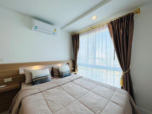 Postel nebo postele na pokoji v ubytování Energy Seaside city Hua-Hin / Cha-am