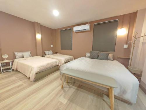 a hospital room with two beds and a table at 57 Hidden House BKK Chinatown in Bangkok